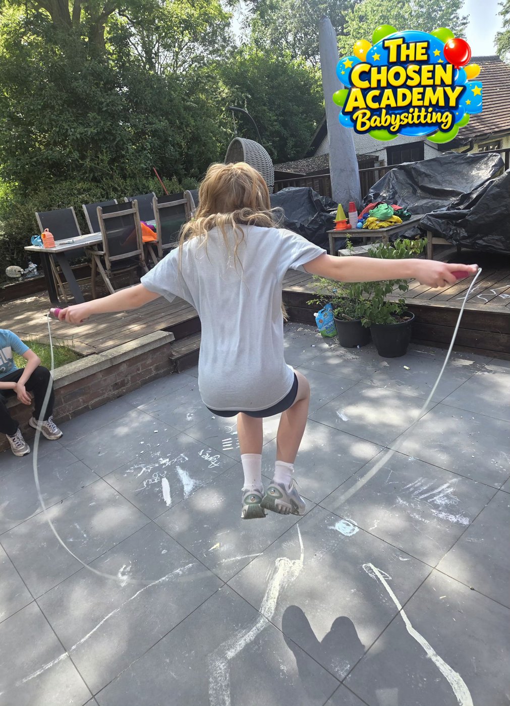 A child taking part in an outdoor chalk activity